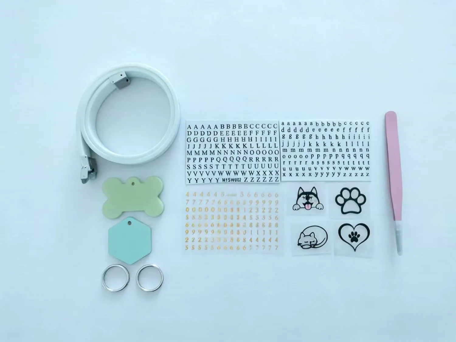 Full kit contents: collar, two charm tags, rings, letter stickers, number stickers, design stickers, and tweezers