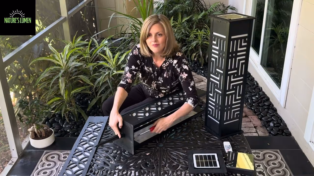 Woman holding screwdriver while assembling bollard light at table